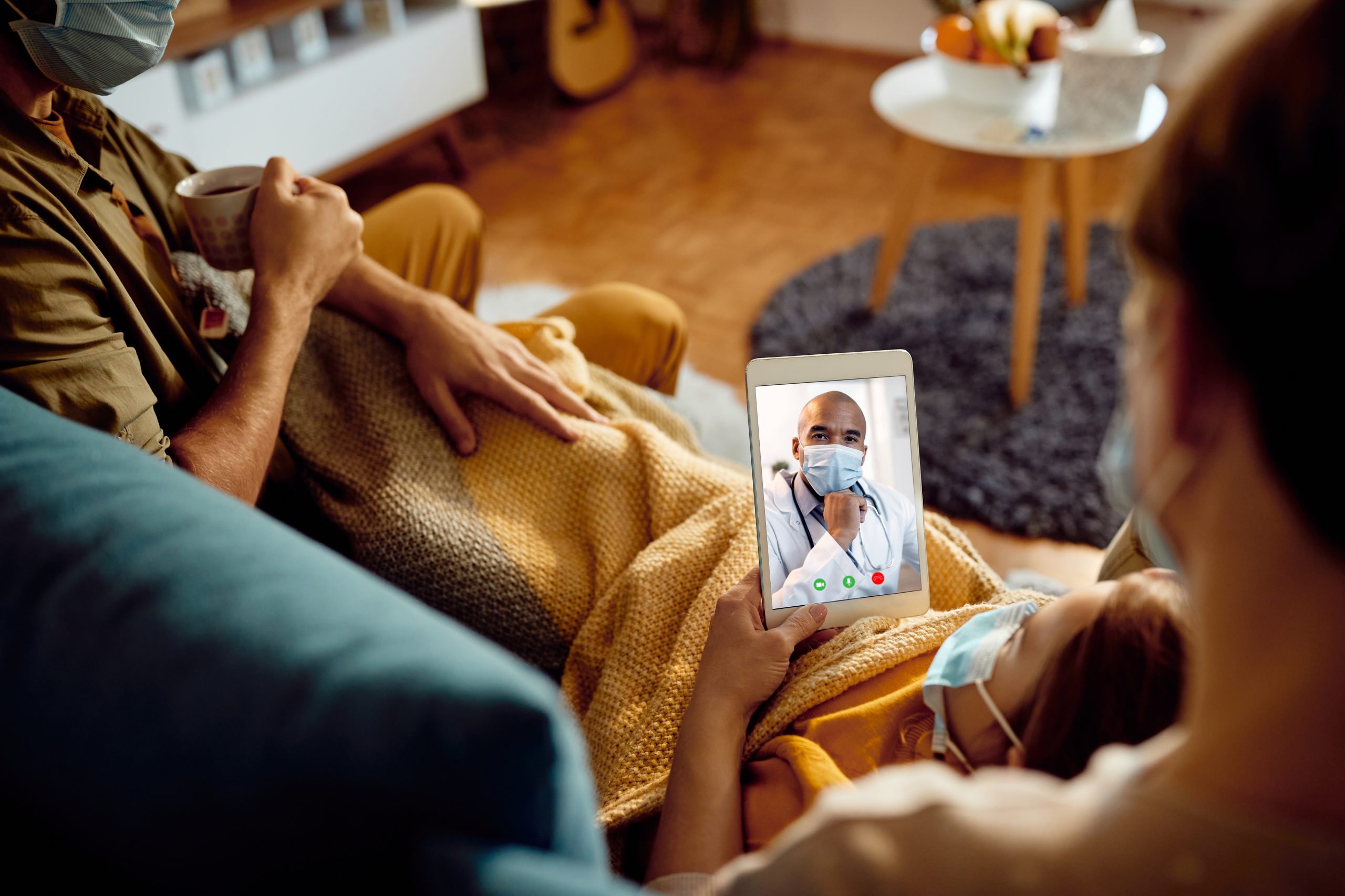 Close-up of family having video call with their doctor from home